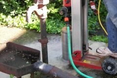 6″ holes are drilled into the well’s concrete slab to prep for interior videotaping.